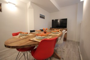 living and dining area with large table and tv