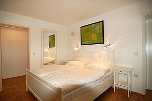 beautiful holiday apartment white furntiture in the bedroom 