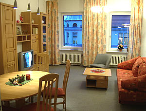 living and dining room with couch, table and tv 